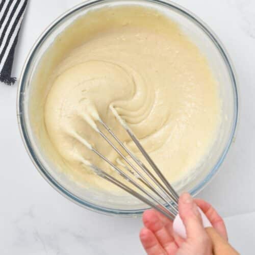 A whisk in a thick glossy almond flour pancake batter