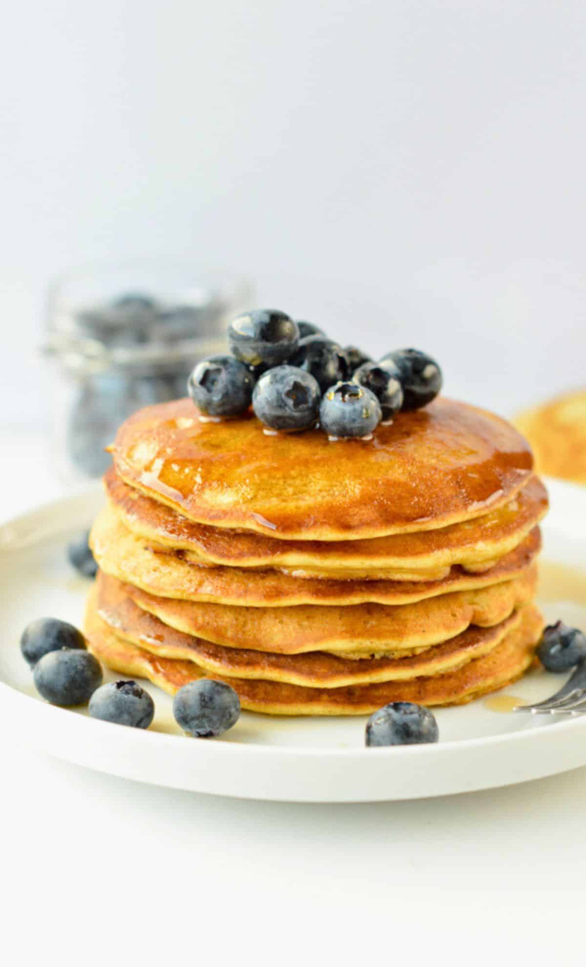 Vegan Chickpea Pancakes decorated with maple syrup and blueberries