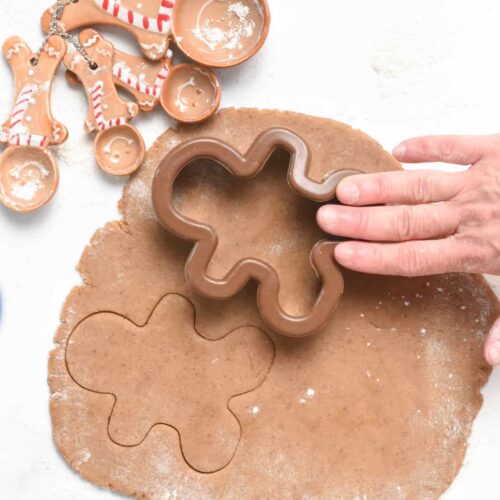 Forming Vegan Gingerbread Cookies with a cookie cutter.