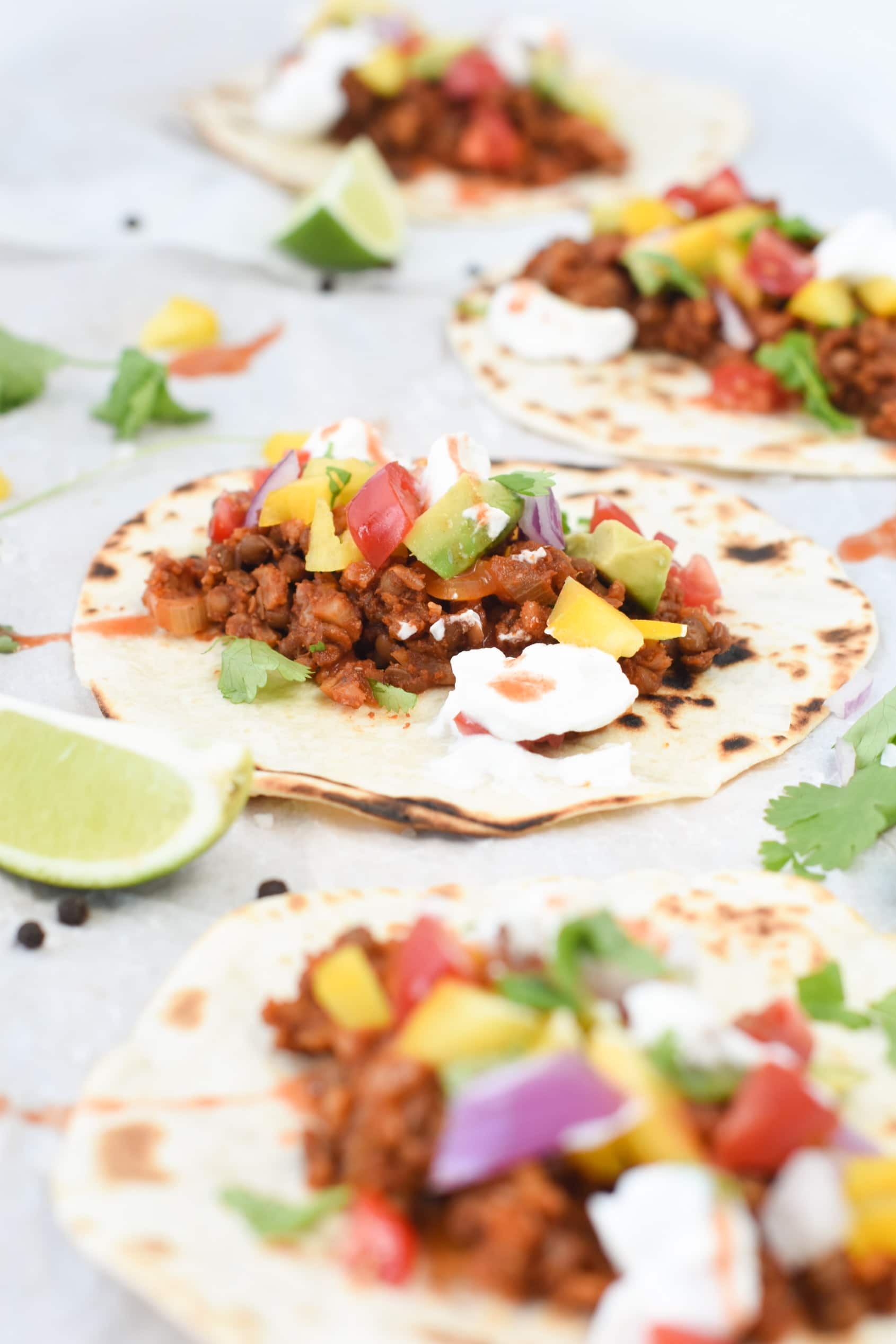 Vegan Lentil Tacos filled with vegan taco meat, vegetables, and vegan cream.