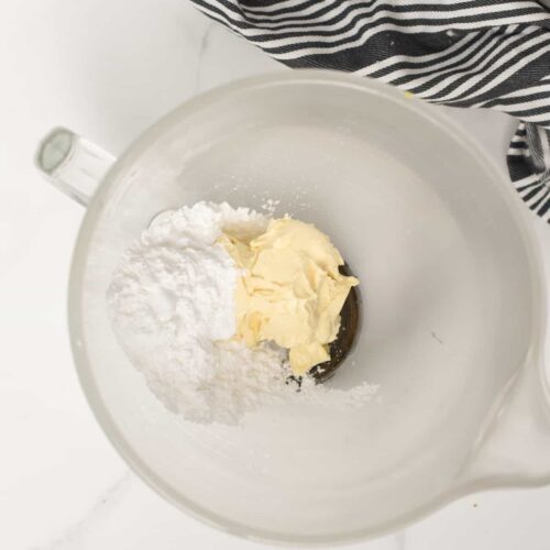 Vegan butter and powdered sugar in a stand mixer bowl.