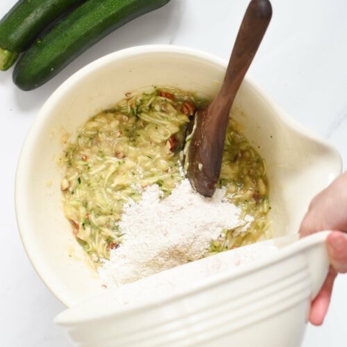 Combining dry ingredients into the wet batter of a Healthy Zucchini Banana bread