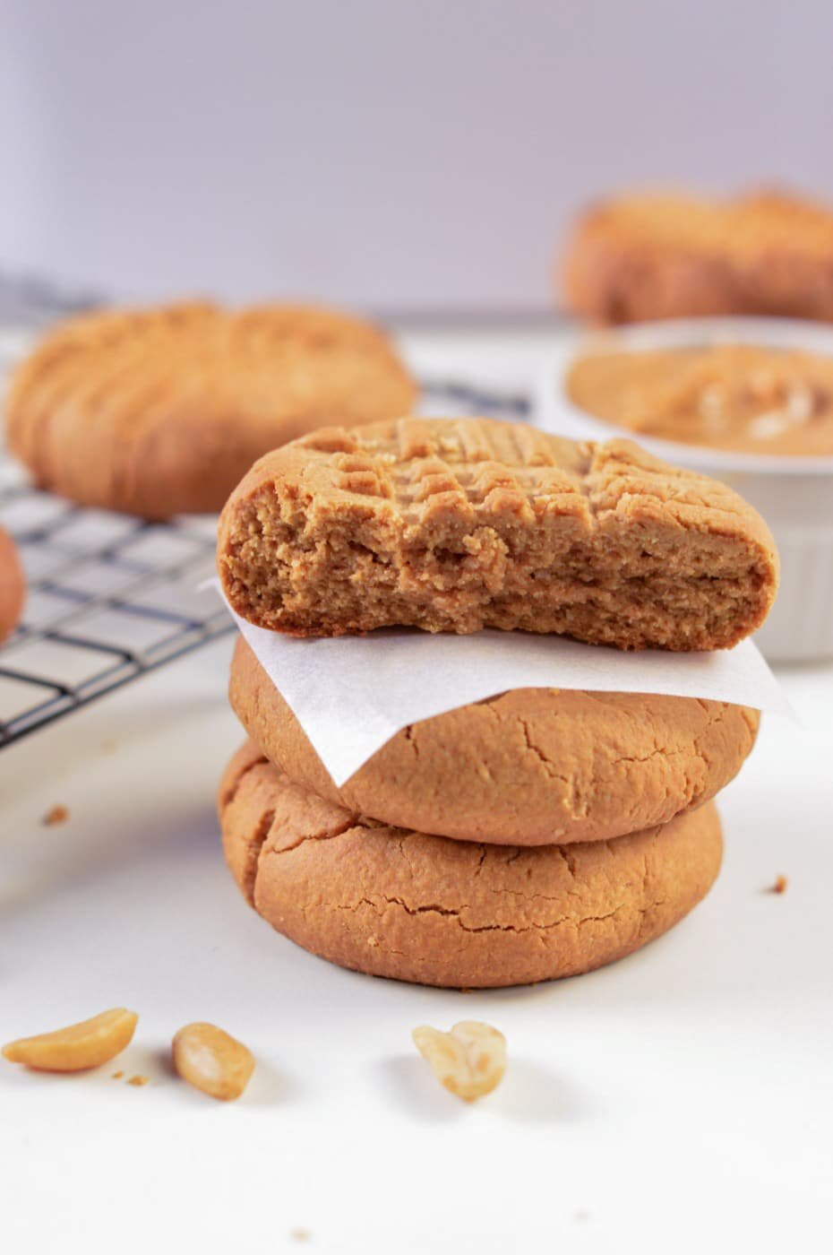 3-Ingredient Vegan Cookies stacked next to a cooling tray.