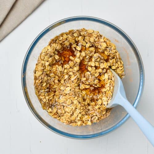 Bowl with granola butter ingredients and a spatula.