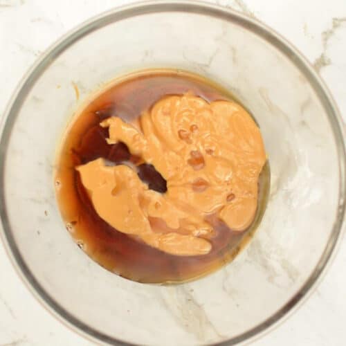 Peanut butter and maple syrup in a mixing bowl.