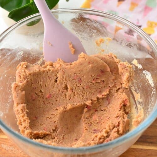 Strawberry Protein Balls Batter in a bowl with a pink silicone spatula