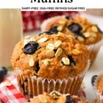 a vegan oatmeal muffin with blueberries,oats on top and placed on red and white round lid