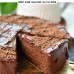 a no-bake chocolate cake with a slice coming out of the cake with a golden spatula