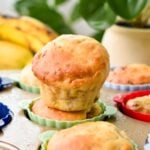 a banana muffin on top of other banana muffins in colored silicon muffin cups