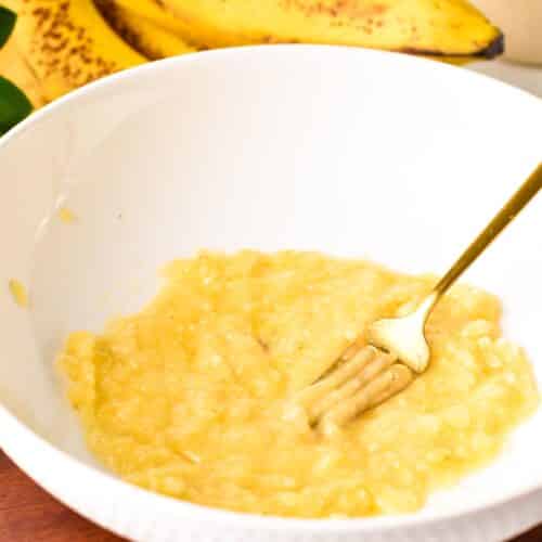 a fork in a bowl with mashed banana