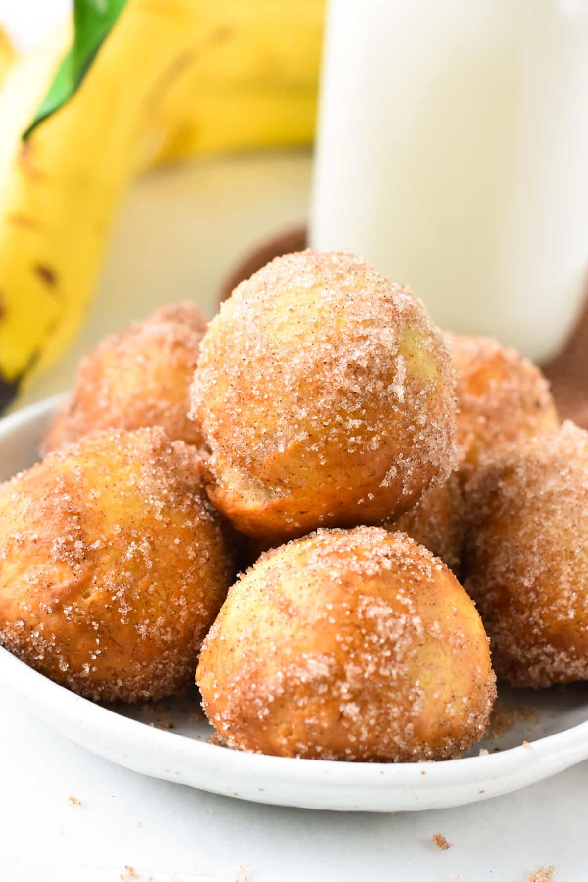 A stack of banana donut holes in a bowl