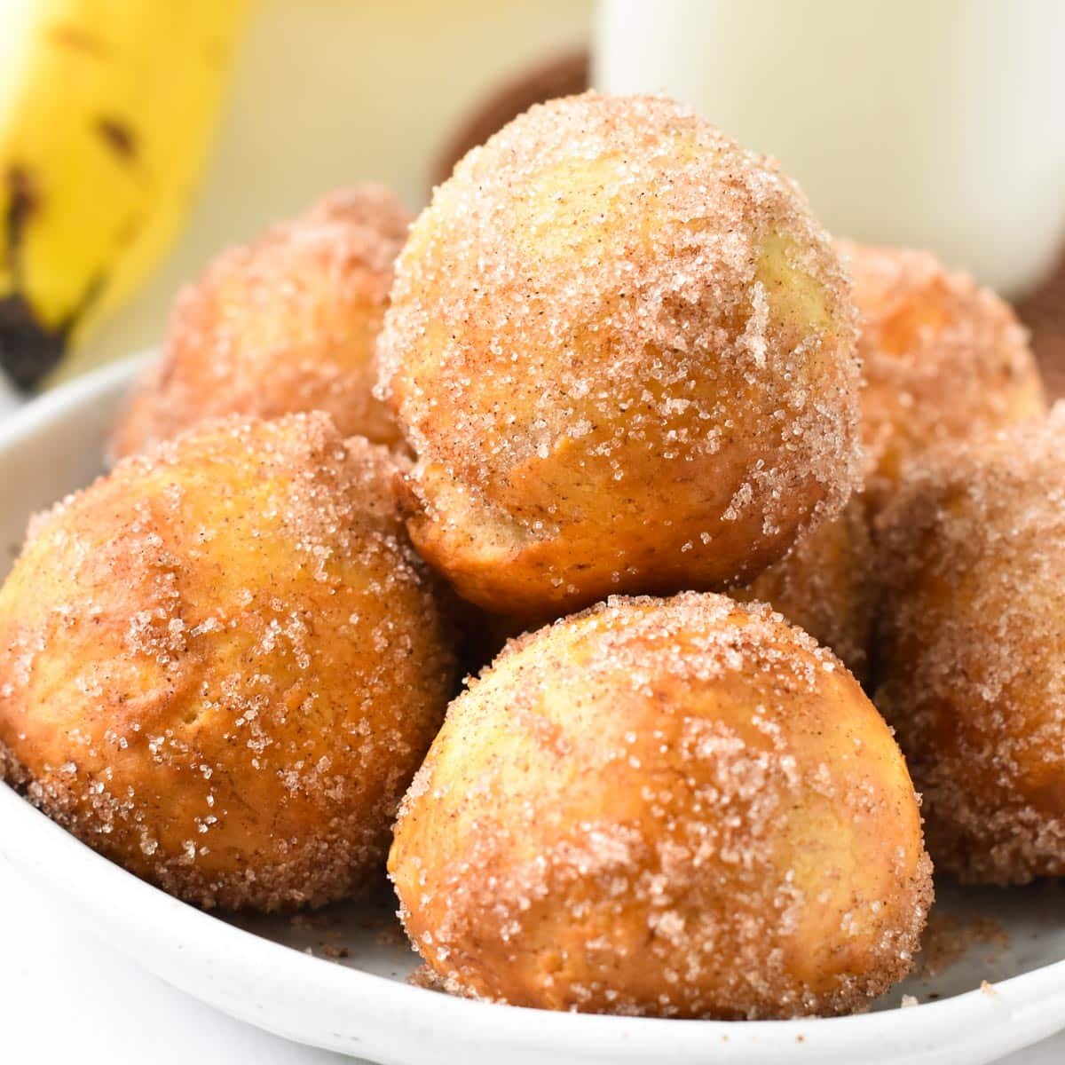 a stack of banana donut holes in a bowl