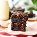 a stack of two squares of healthy brownies with melted chocolate chips