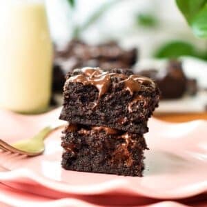 a stack of two squares of healthy brownies with melted chocolate chips