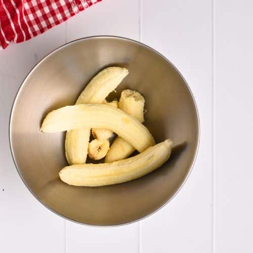 Peeled bananas in a mixing bowl. 