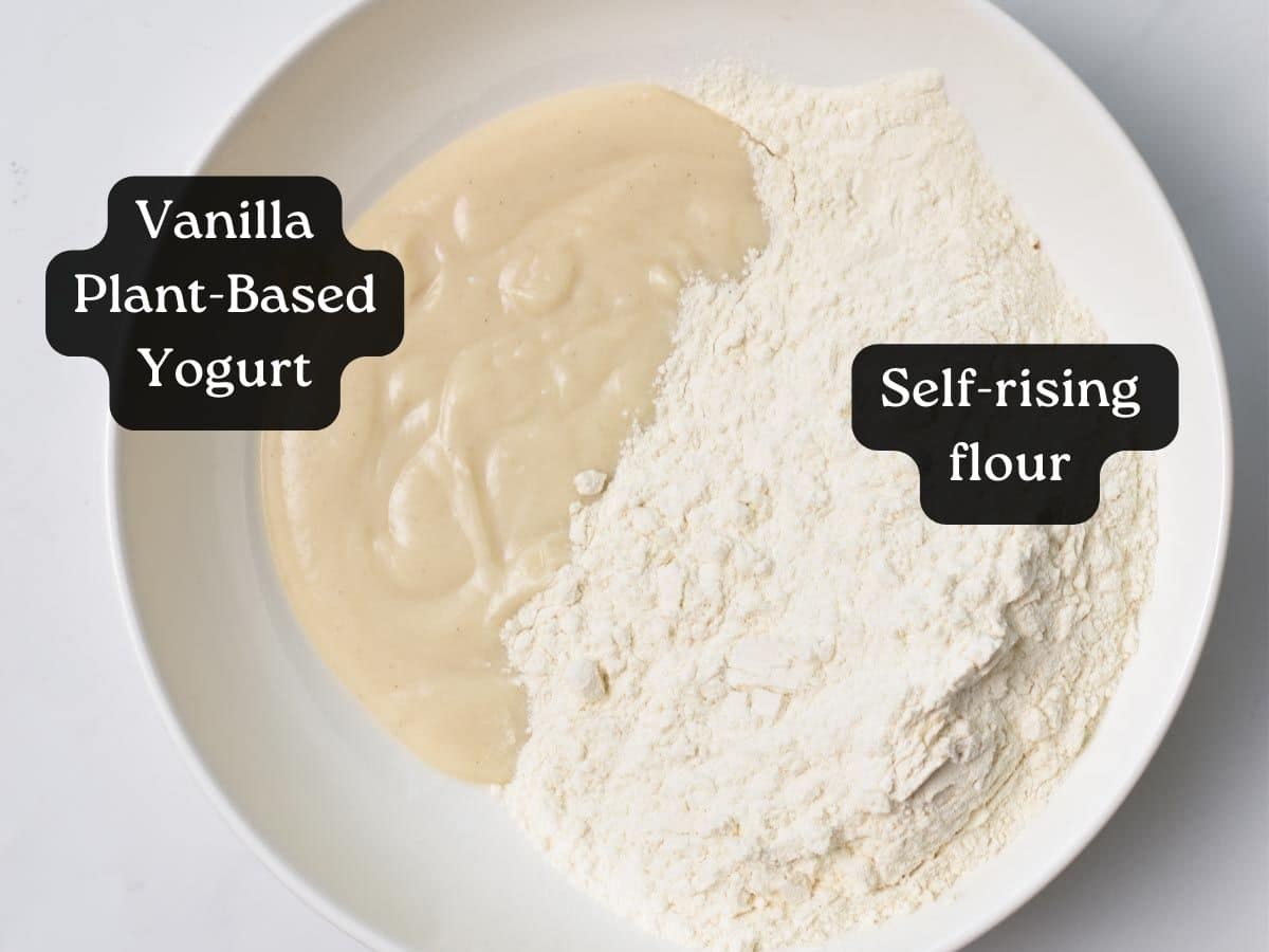 A mixing bowl with two ingredients : yogurt and self-rising flour