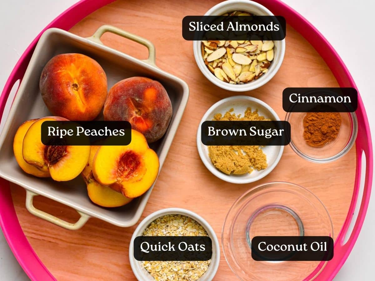 a picture of the ingredients to make air fryer peaches: fresh peaches, pitted, halved, brown sugar, sliced almonds, oats, coconut oil and cinnamon