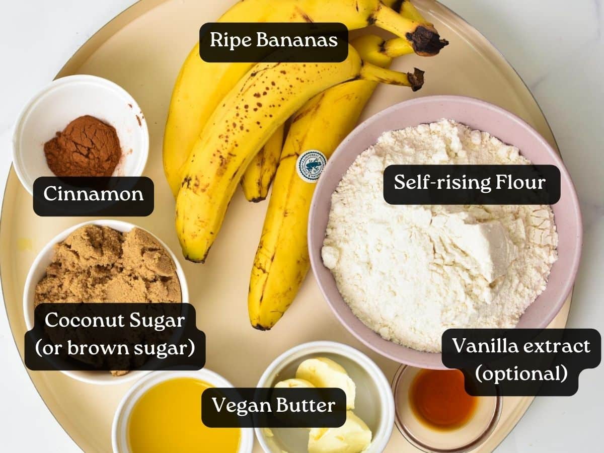 A picture of the ingredients used to bake banana bread cinnamon rolls: ripe bananas, brown sugar, butter, cinnamon, self-rising flour, vanilla extract and melted butter.