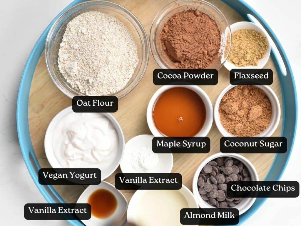 Ingredients for Vegan Yogurt Brownies in bowls and ramekins with labels.