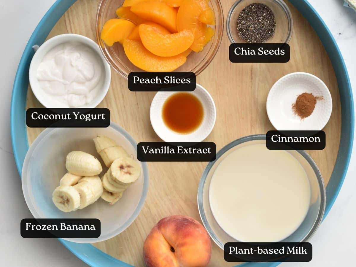 Ingredients for Banana Peach Smoothie in bowls and ramekins on a serving tray.