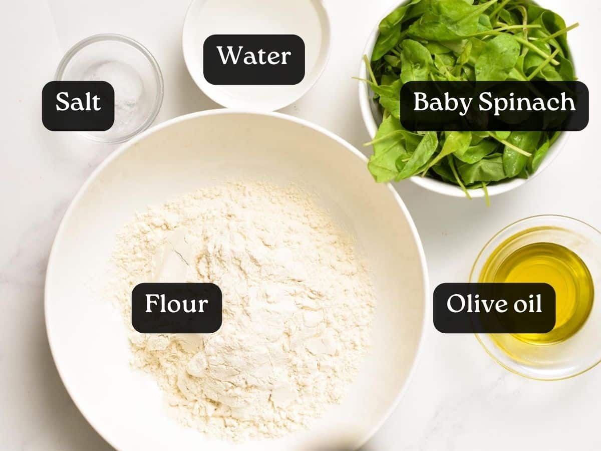 Ingredients for Spinach Tortillas: bowls filled with water, olive oil, salt and fresh baby spinach