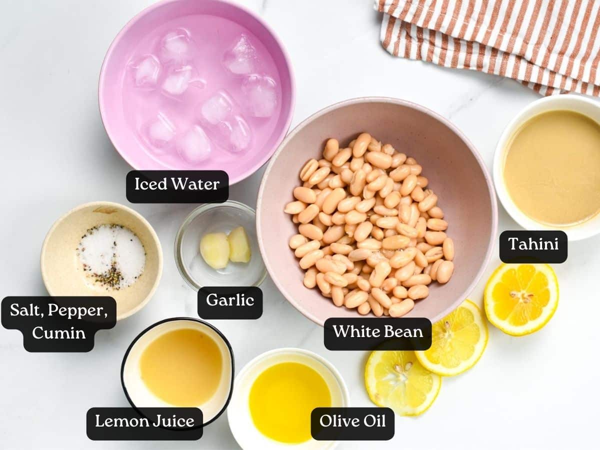 Ingredients for Vegan White Bean Dip in bowls and ramekins.