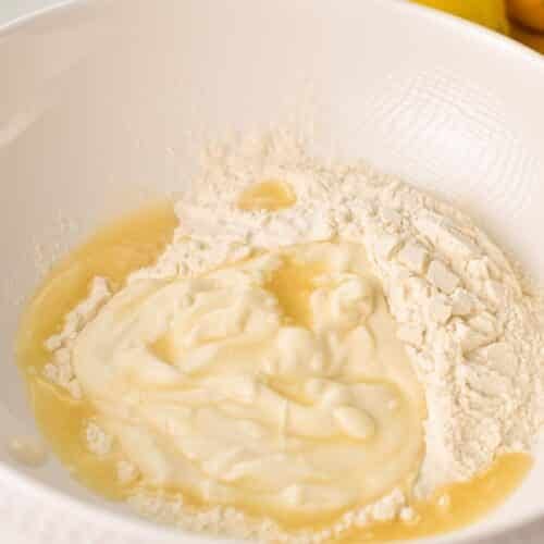 a mixing bowl with flour, yogurt and lemon juice