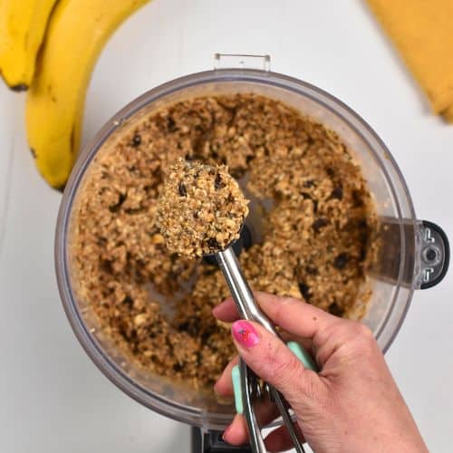 Scooping the Banana Oat Balls batter out of the food processor.