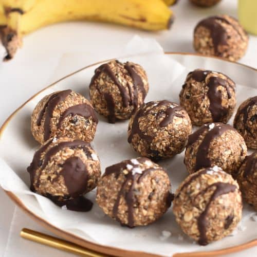 Banana Oat Balls rolled on a plate with parchment paper.