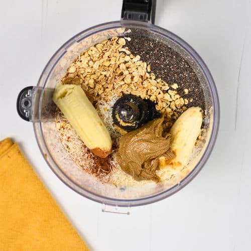 Banana Oat Balls ingredients in the bowl of a food processor.