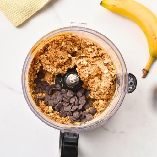 Banana Protein Ball batter with chocolate chips in a food processor.