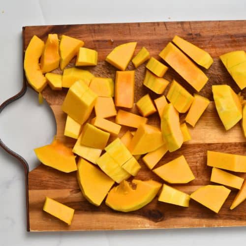 Butternut squash chopped on a board.