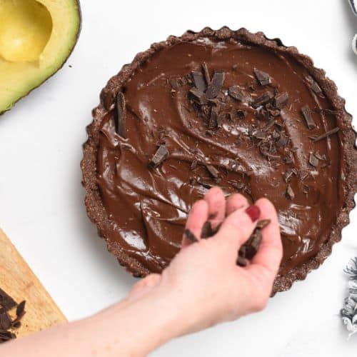 Adding chocolate chunks on the chocolate avocado pie.