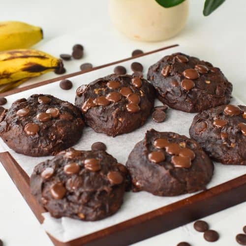 Chocolate Banana Cookies cooling on a chopping board.