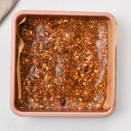 Healthy Date Bar crust pressed in a square pan.