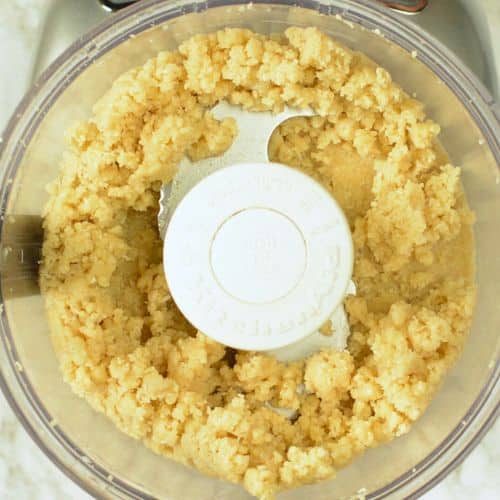 No-bake coconut cookie batter in the bowl of a food processor.