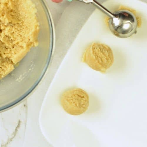 Rolling balls of no-bake coconut cookie dough.