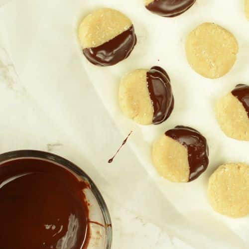 Dipping no-bake cookies in melted chocolate.