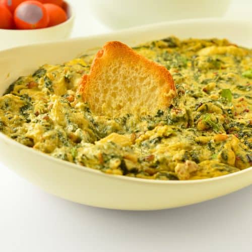Vegan Spinach Artichoke Dip served with toasted bread.