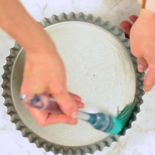 Oiling the pan for the vegan pean pie