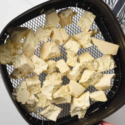 Cut tofu chunks in an air fryer.