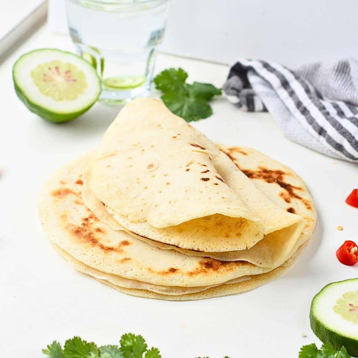 Paleo tortillas stacked on a table.