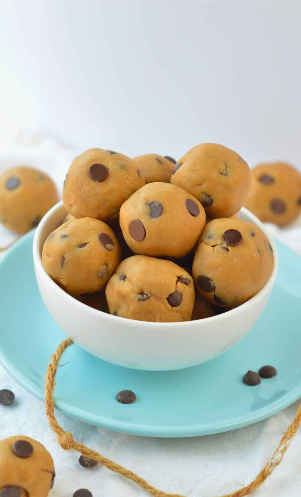 Vegan Cookie Dough Balls in a small bowl on a blue plate.