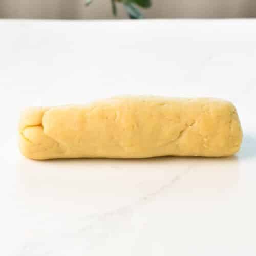 a cylinder of churros dough