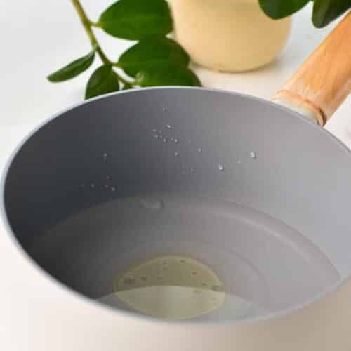 a non-stick saucepan filled with water and oil 