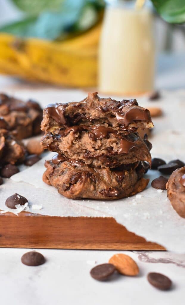 Banana Protein cookies split and stacked on a chopping board.