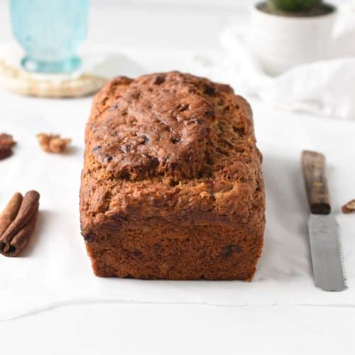 Eggless banana bread cooling down on a white table.