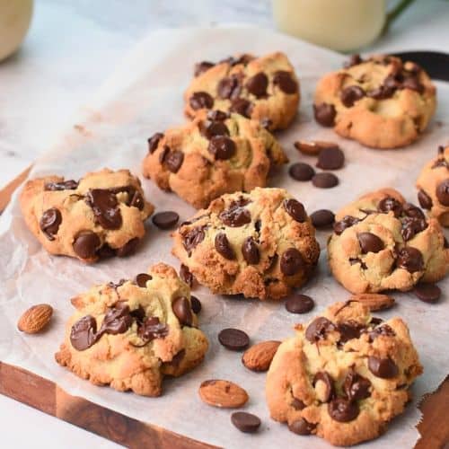 almond flour chocolate chip cookies cooling down on a chopping board.