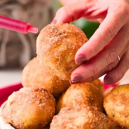 Jam in a syringe to insert into the donut holes.