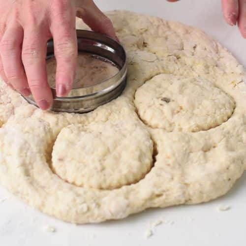 Cutting banana scones with a cookie cutter.